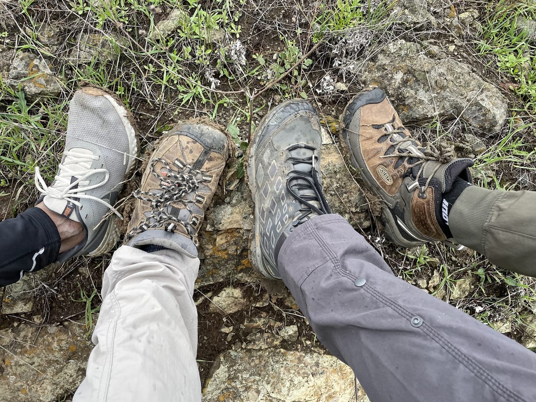 Four pairs of muddy boots